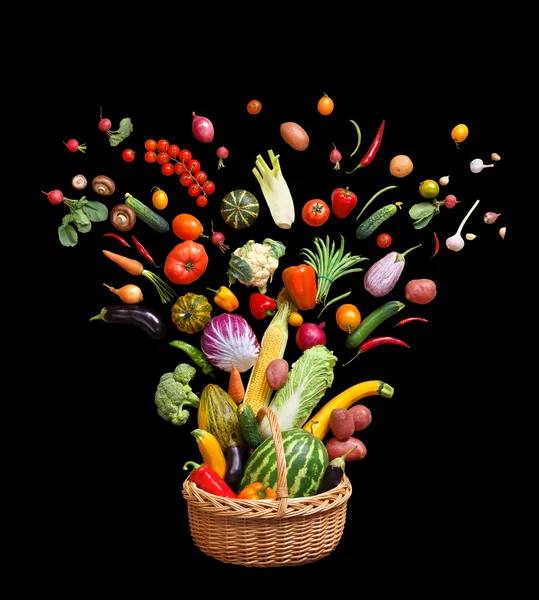 Studio photography of different fruits and vegetables isolated on black background.