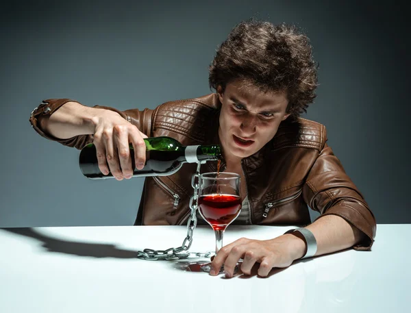 Young man with bottle of alcohol