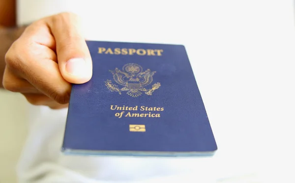 Hand Holding an American Passport Isolated