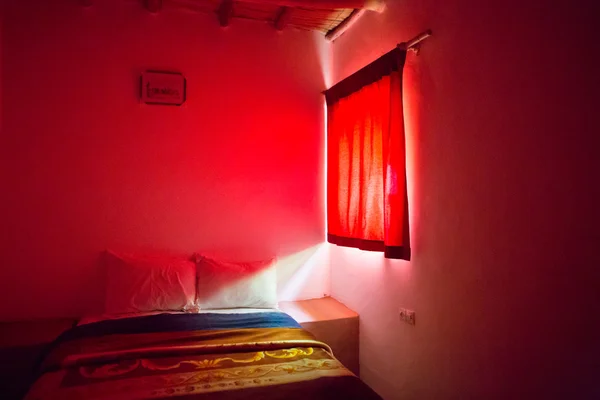 Authentic Moroccan bedroom in traditional riad with red light