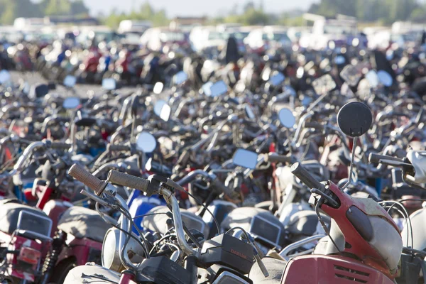 Large group of motorbikes and scooters in Police parking