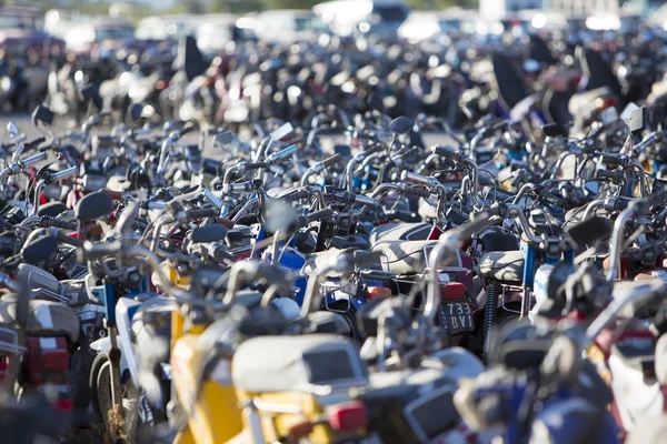 Large group of motorbikes and scooters in Police parking