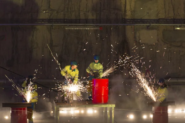 Welders in action with bright sparks during the opening show of
