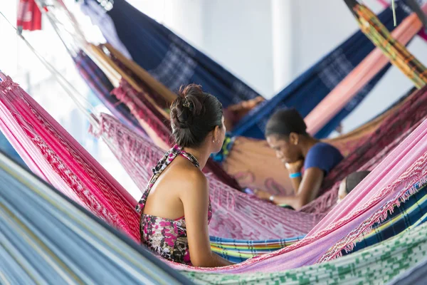 People resting in hammocks on passenger boat deck, Brazil