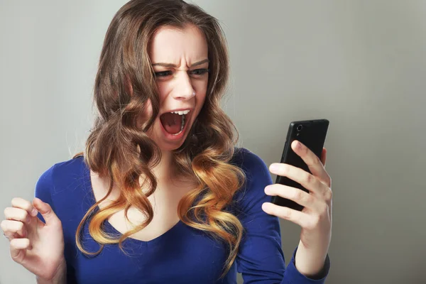 Shocked woman look at phone