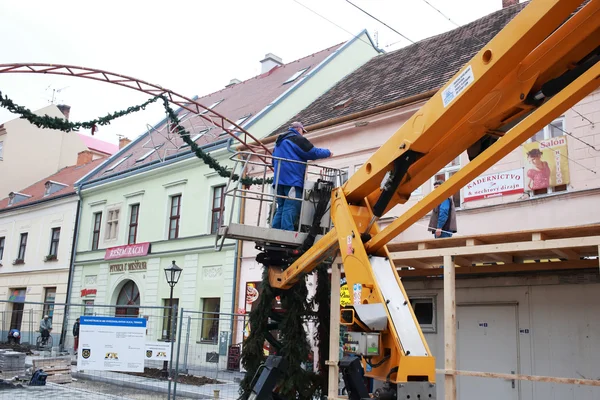 Workers apply christmas decoration