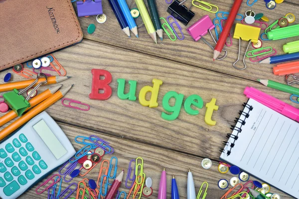 Budget word and office tools on wooden table