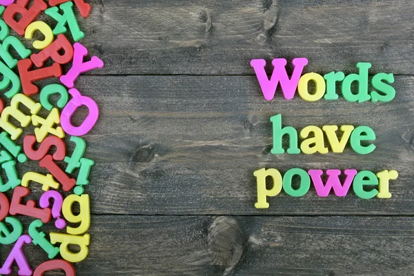 Words have power on wooden table