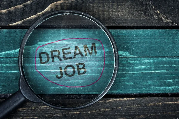 Dream Job text painted and magnifying glass on table