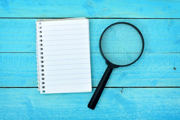 Magnifying glass and notepad