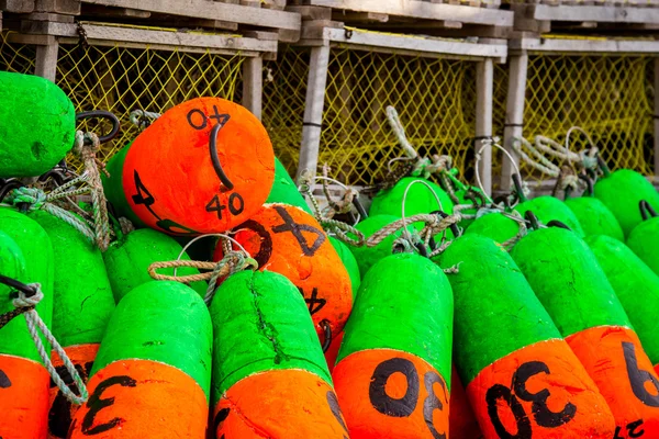 Green and orange lobster buoys