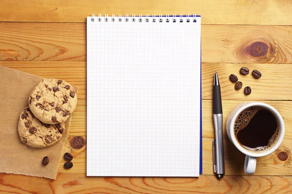 Coffee with cookies and notepad