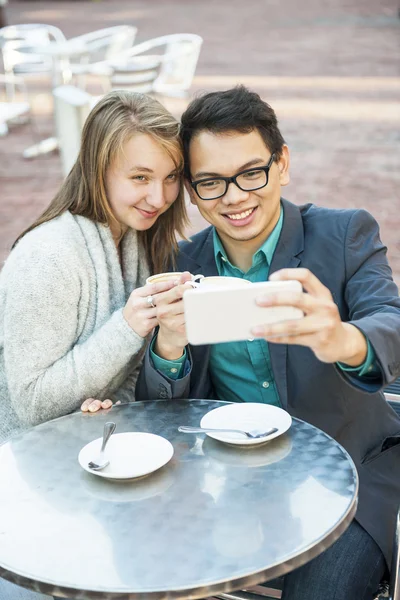 Young people taking a selfie in cafe