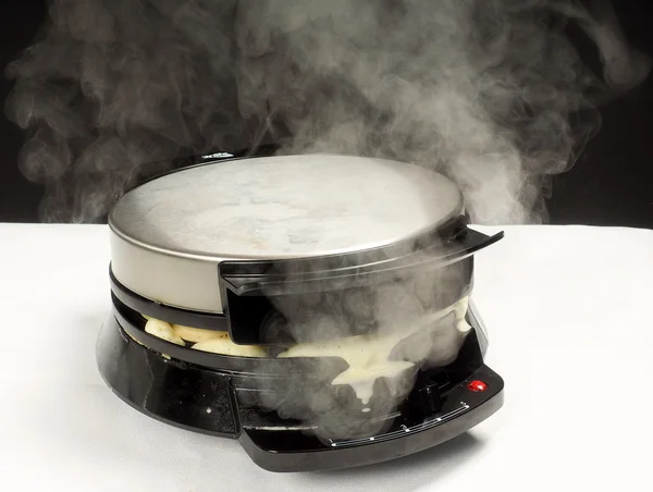 Making of fresh steaming hot waffles