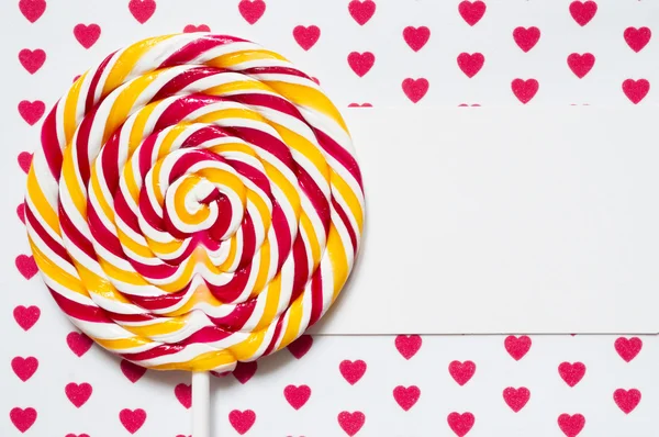 Lollipop on a background with hearts