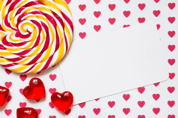 Lollipop on a background with hearts and a list of paper for your text.