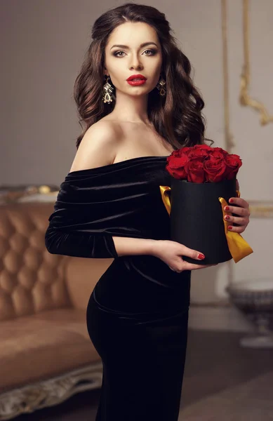 Pretty girl standing with red roses