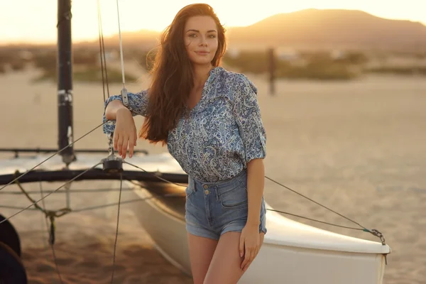 Young beautiful pretty girl sitting at sailing catamaran