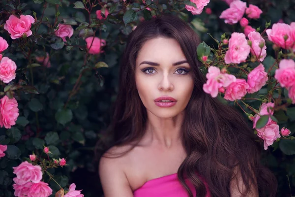 Romantic beauty portrait of woman in pink roses