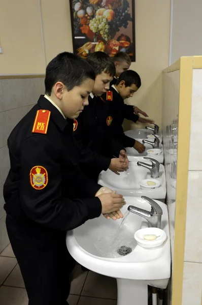 Washing hands before eating in the dining room in the cadet corps of the police.