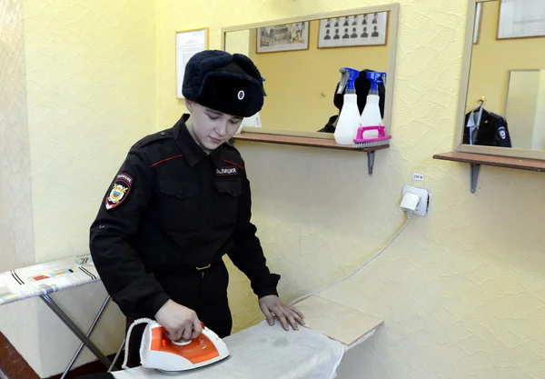 Soldiers of internal troops stroking form in the utility room of the barracks.