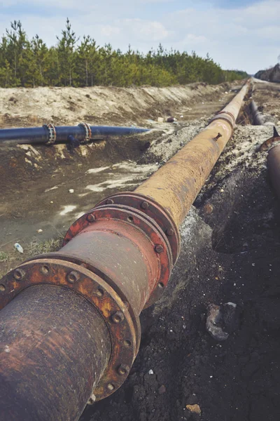 Steal big pipeline on a ground. Old pipes joint.