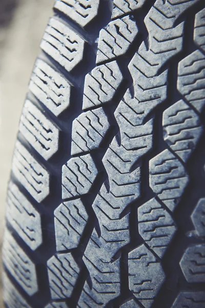Dirty car tire on a dusty road. Look of tread dirty because of dust, sand and powder.
