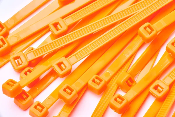 Orange cable ties. Commercial photo on white background.