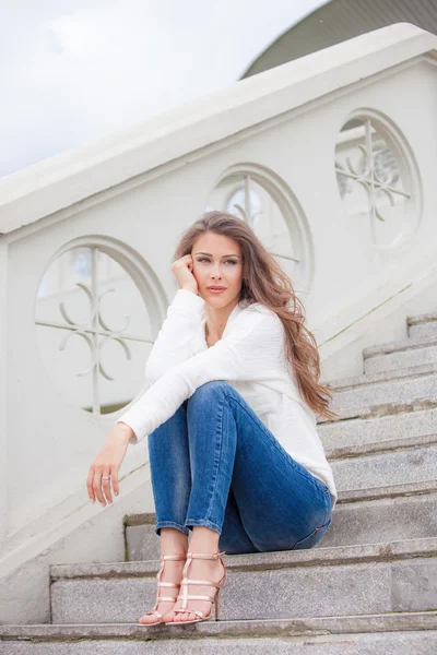 Young woman sit on stairs