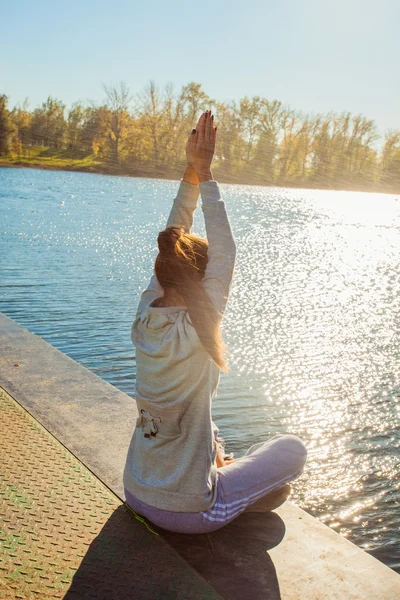 Practice yoga by the lake
