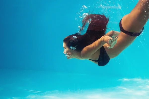 Woman dive in pool
