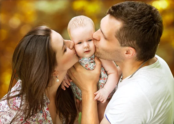 Happy family having fun in the park in autumn