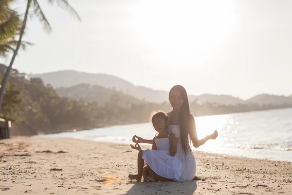 Mother and daughter happy in love at sunset