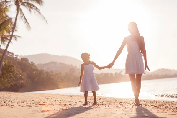 Mother and daughter happy in love at sunset