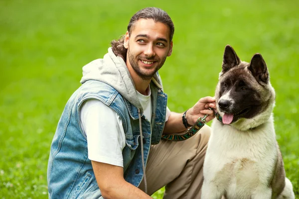 Man with his dog breed Aki