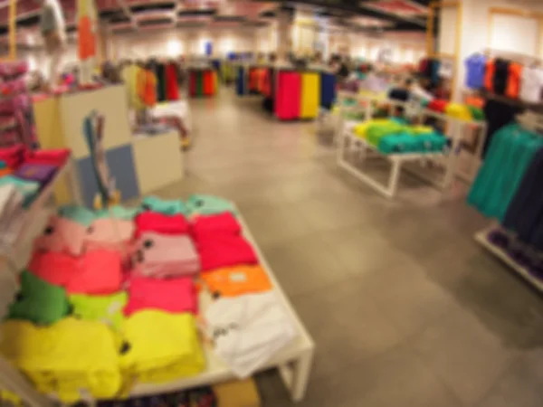 Defocused and blurry image of the interior of a clothing store