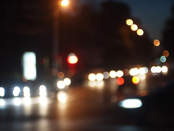 Blurred out of focus lights from cars in a night scene