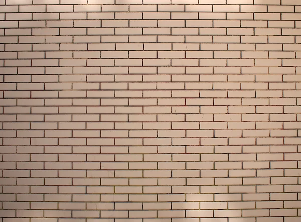 Fragment of a brick wall beige with neat rows of masonry