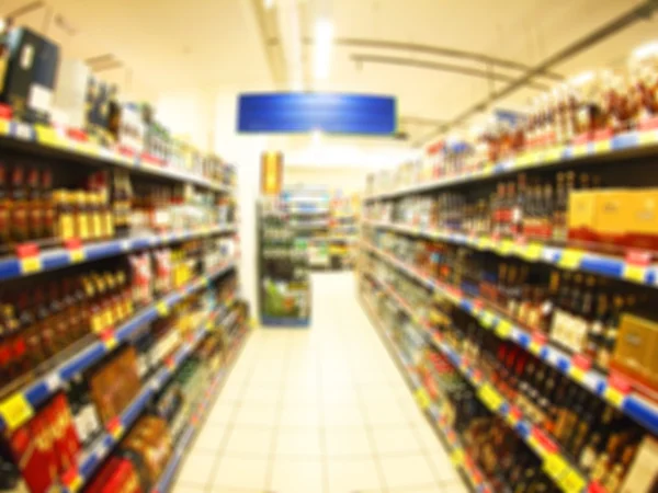 Blur view of the shop interior with shelves with alcohol