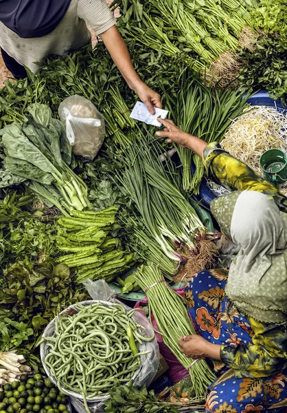 Woman selling fresh vegetables