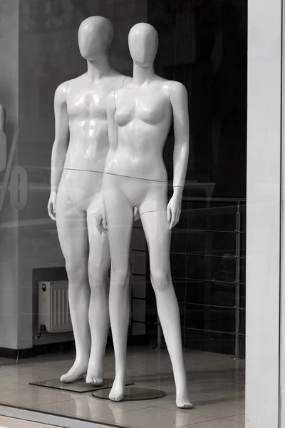 Mannequin naked man and woman in itrine store selling interest