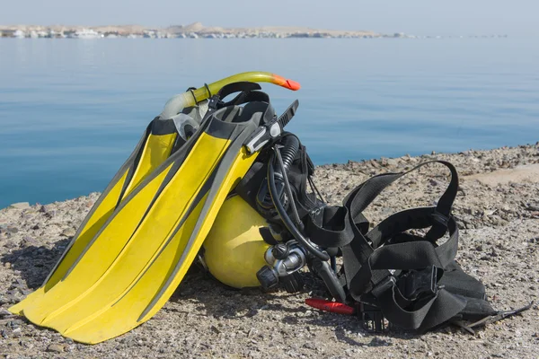 Set of scuba diving equipment by the sea