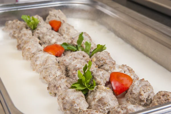 Meat balls in white sauce at a restaurant buffet