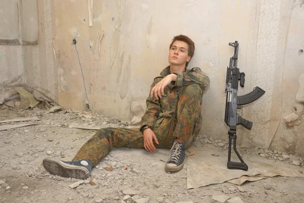 Teenager, boy in battle dress and a rifle, Air Soft Gun