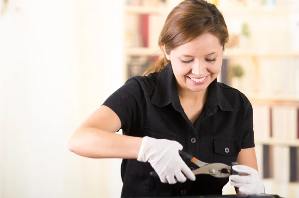Young woman wearing black shirt performing toner change and printer maintenance, positive attitude smiling