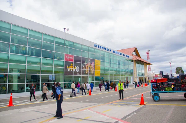 Cuenca, Ecuador - April 22, 2015: Passengers entering airport terminal building from runway area, red cones and markings on surface
