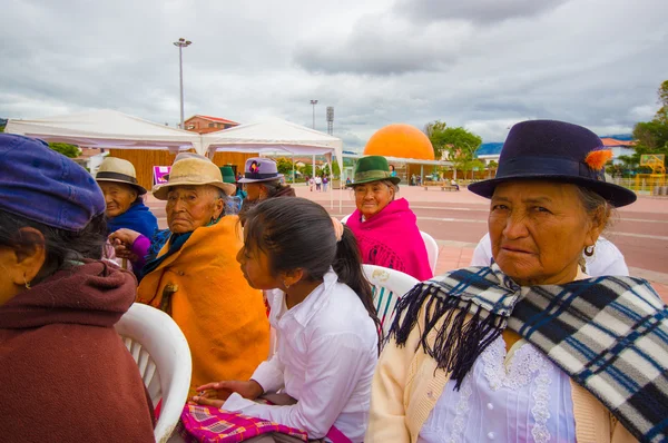 Cuenca, Ecuador - April 22, 2015: Local old people enjoying a musical performance on city square, ladies clapping and smiling
