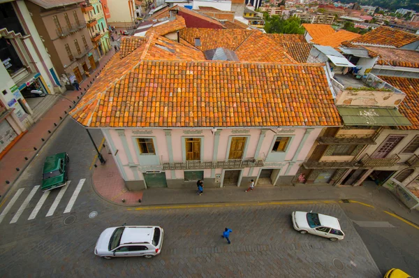 Cuenca, Ecuador - April 22, 2015: Typical townhouse with distinct red shingle rooftop as seen from high above, mild traffic outside