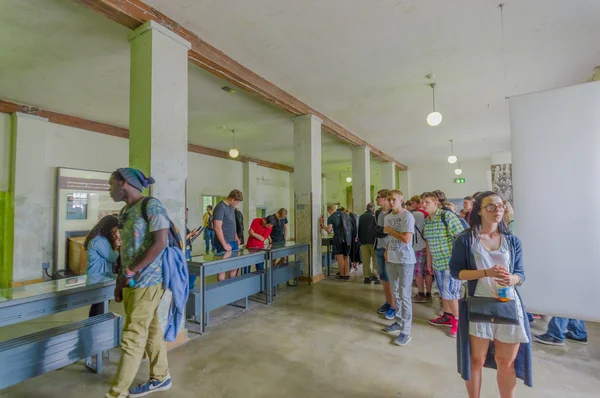 Dachau, Germany - July 30, 2015: Crowd of people looking inside museum buildings concentration camp