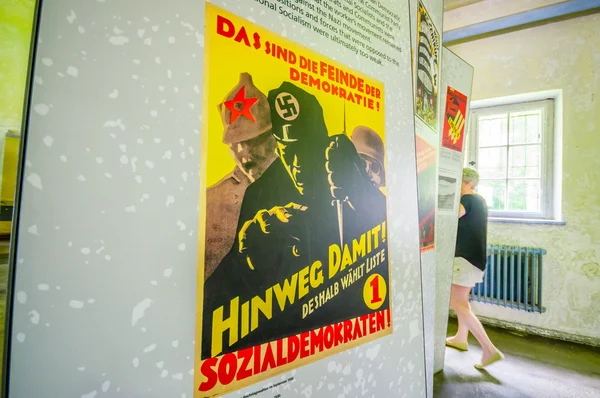 Dachau, Germany - July 30, 2015: Nazi propaganda poster from world war 2 found inside museum of concentration camp